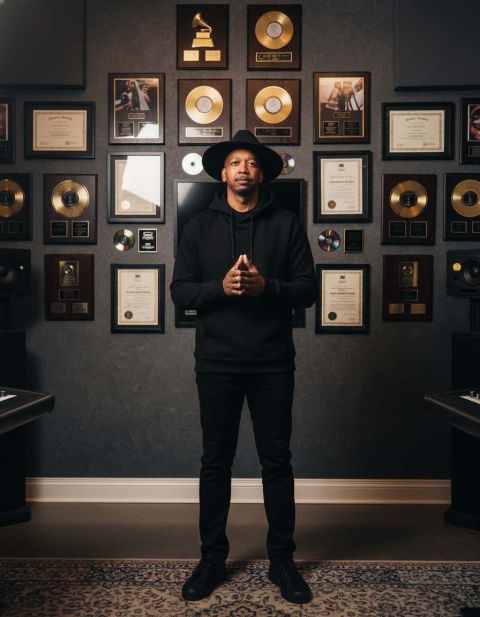Marcus &ldquo;Bellringer&rdquo; Bell in front of his gold & platinum plaques and Grammy